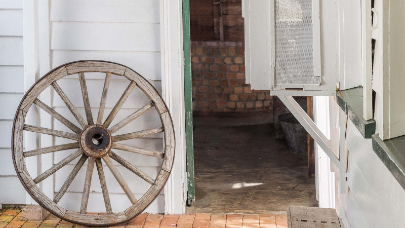 Wagon wheel leaning against the building at Alberton