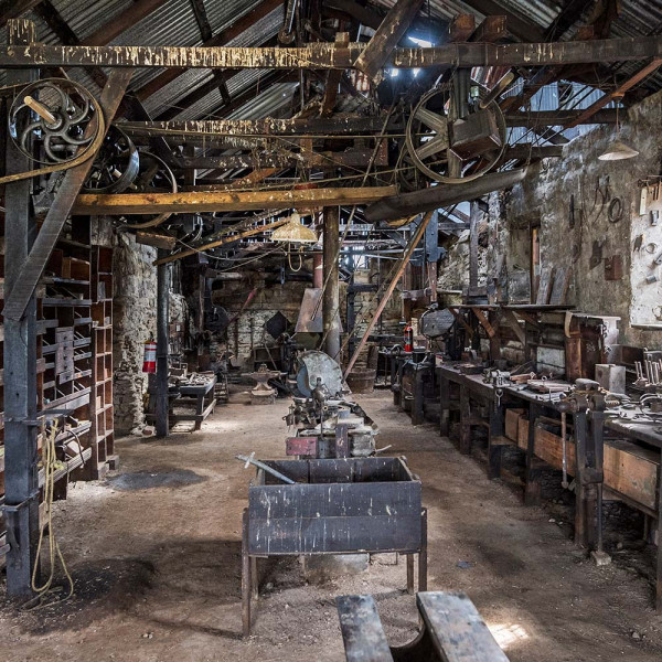Interior of the Hayes Engineering workshop showing all the machinery, pullies, tools and more.