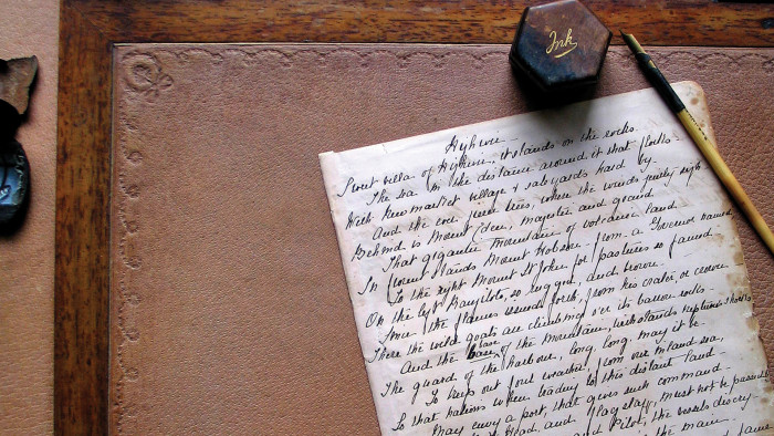 Letter on desk with ink pot and pen