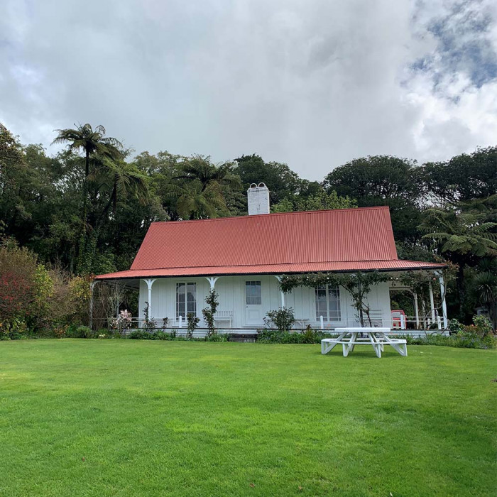 Exterior of Hurworth Cottage across the lawn situation in native bush