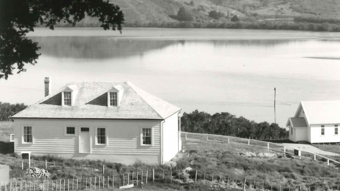 Historic black and white photo of Māngungu Mission from behind the house on the hill over looking the church and the Hokianga harbour