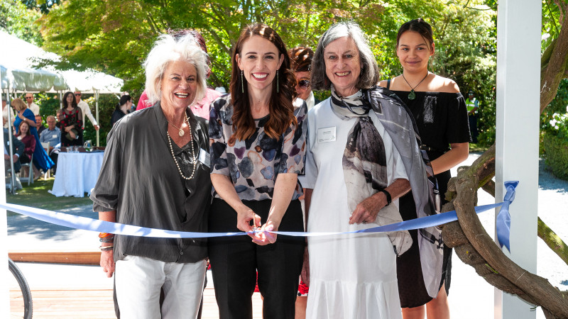 Prime Minister Jacinda Ardern cutting the ribbon to open Kate Sheppard House with family members in 2020