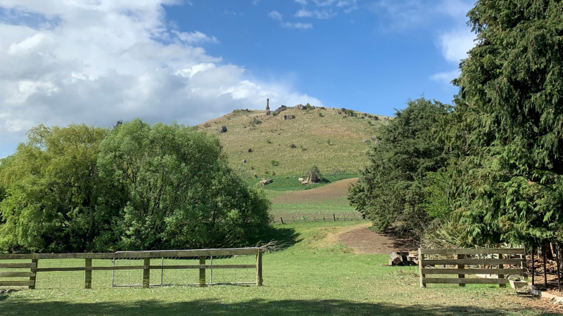 View of the Brydone Monument across the paddock and up the hill from next to Totara Estate