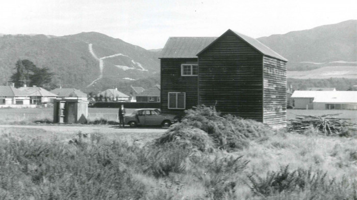 Historic black and white photo of Upper Hutt Blockhouse in 1937 with hills in the background