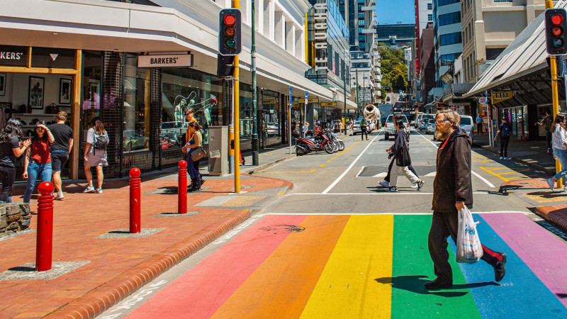 People walking across the rainbow crossing on Cuba Street, Wellington