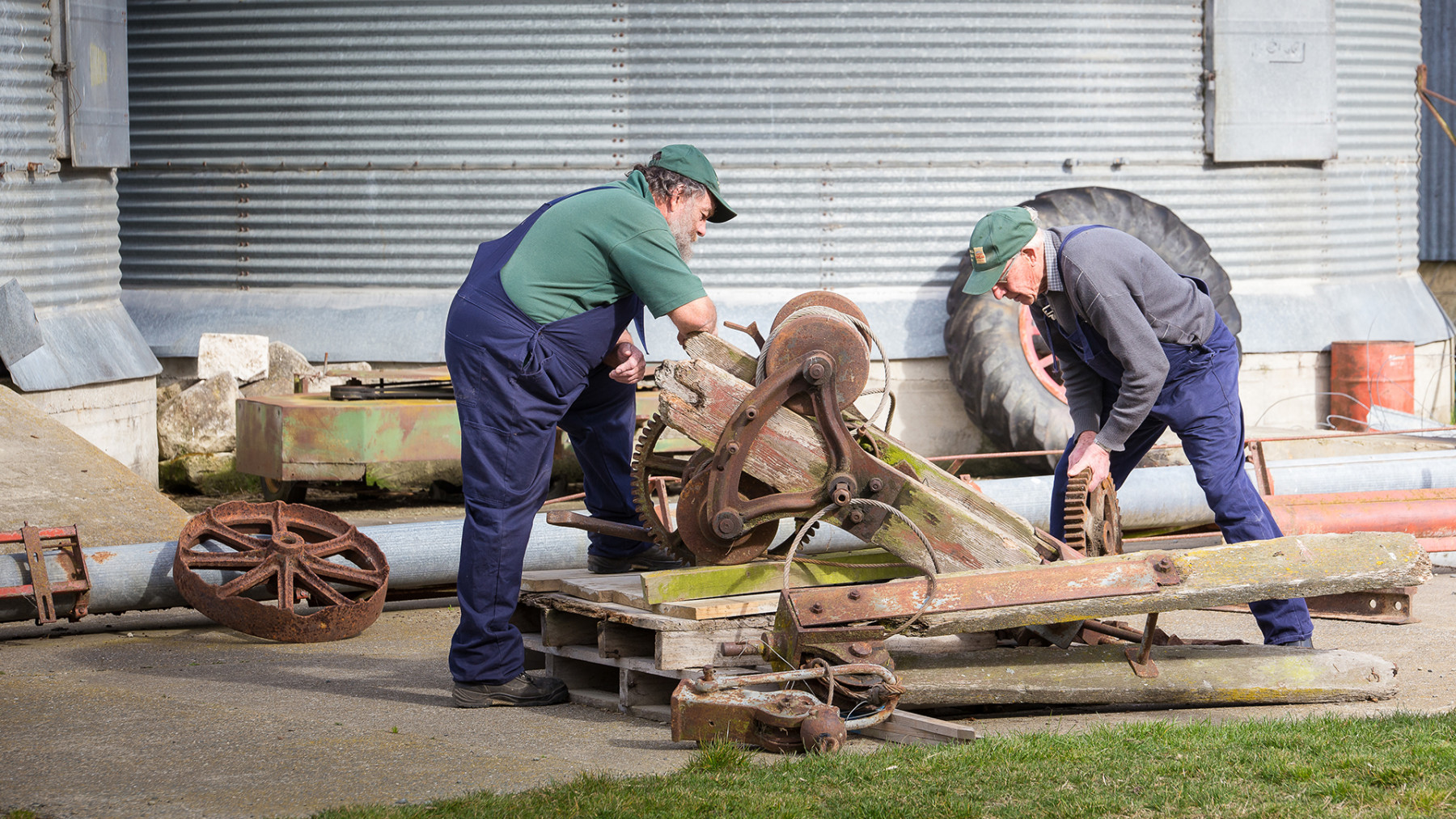 Two men work on restoring equipment for the mill