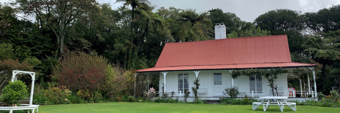 Exterior of Hurworth Cottage across the lawn situation in native bush